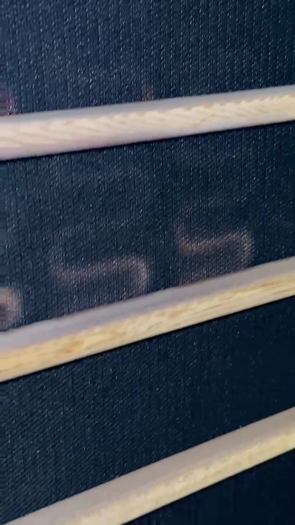Scorched heating element traces glowing through the panel fabric of a Huizhou Alpha Sauna infrared panel